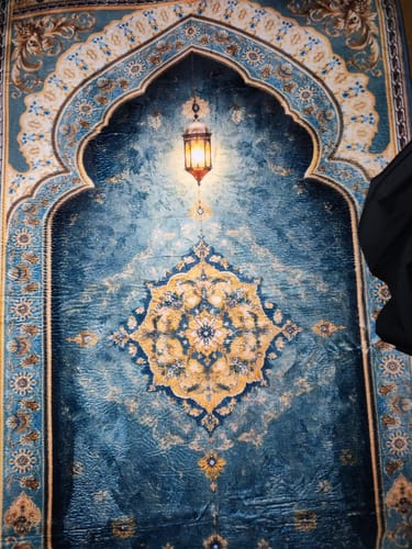 Customer's Celestial Bloom Padded Prayer Mat featuring a deep blue arched design and a glowing lantern motif.
