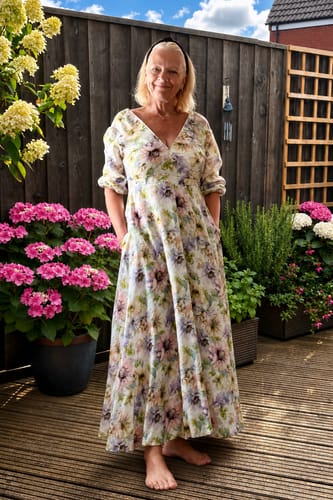 Customer's floral Garden Delight Linen Viscose dress with sleeves, worn outside on a wooden deck.