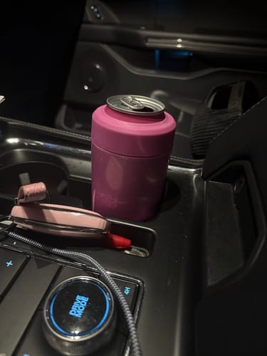 Customer's pink Frost Buddy can cooler holding a beverage in a vehicle cup holder.