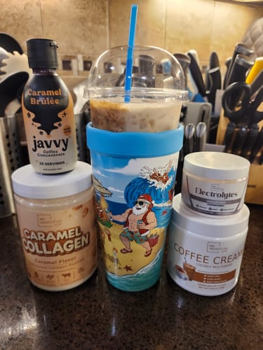 Customer's Frost Buddy cup on a table with coffee concentrate, collagen, and creamer.