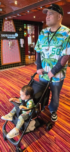 Customer's Personalized Multicolor Palm Tree Hawaiian Style Baseball Jersey worn by a person pushing a baby in a stroller