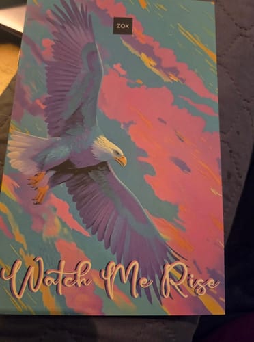 Customer's August 2026 Booklet, showing a vibrant pink, blue, and purple eagle flying on the cover.