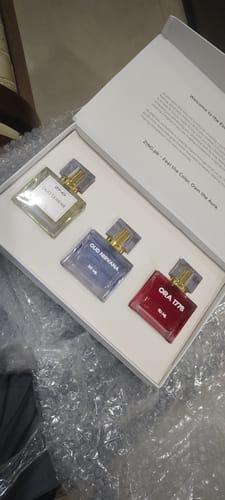 Customer's OUD Supreme Bundle set featuring three colorful glass perfume bottles arranged inside a white box.