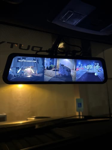 Customer's WOLFBOX G900TriPro rearview mirror installed in a vehicle, displaying a triple camera split-screen view at night