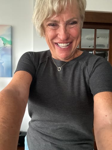 Reviewer smiling while wearing the charcoal Zen Everyday Waffle Tee.