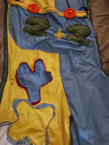 Customer's Mango cotton fabric pieces sewn into a blue and yellow apron project with red and yellow felt attachments
