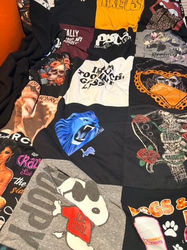 Customer's Project Repat T-Shirt Quilt featuring various graphic prints and black fabric panels.