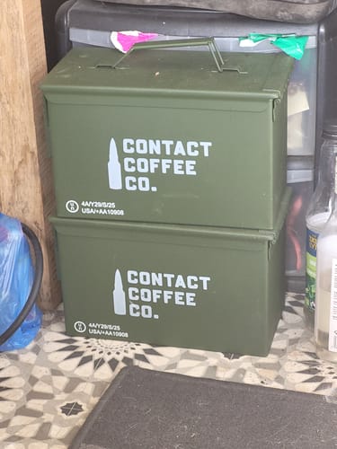 Customer's two green Contact Coffee Co. steel ammo tins stacked on top of each other.