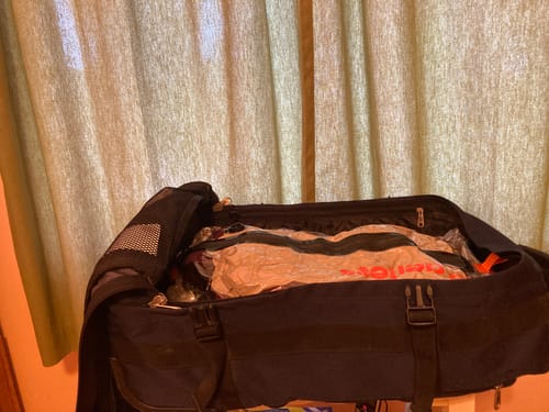 Customer's Aerless Vacuum Bag, compressed and inside an open navy carry-on suitcase.