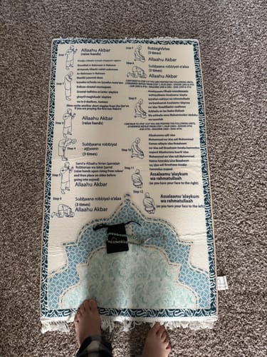 Customer's Step-by-Step Phonetic Salah Padded Prayer Mat featuring illustrations and text, with a tasbih on top.