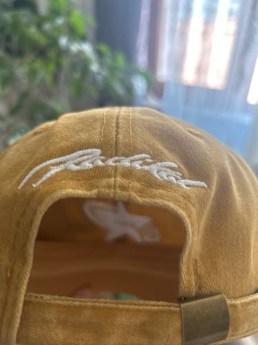 Customer's Radikal Merch acid wash şapka showing the back metal adjustment buckle and embroidered script logo.