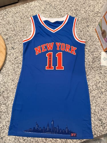 Customer's blue New York basketball jersey with orange and white trim, front view.