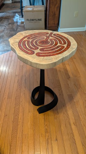 Customer's Table Base Python with a circular wood tabletop in a home setting.