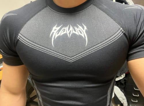 Customer's black Warrior X Compression Tee worn on the torso, showing the fitted cut and tribal-inspired chest logo.