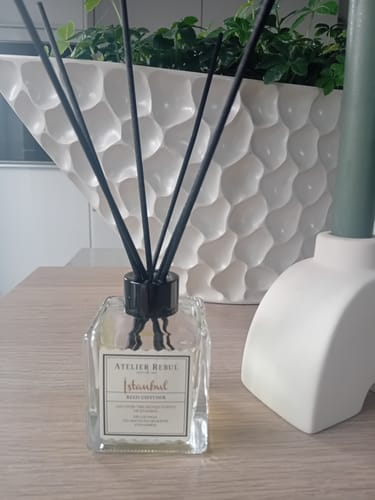 Customer's Atelier Rebul Istanbul reed diffuser with black sticks, sitting on a wooden surface.