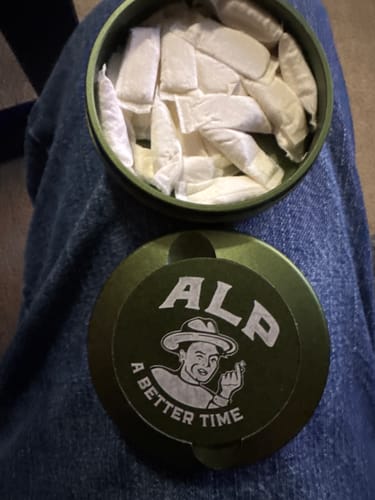Customer's open green can of Sweet Nectar Nicotine Pouches, showing a full supply of white pouches.