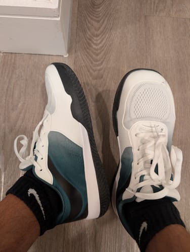 Reviewer's CUURT Muuv wide toe box court shoes in white and teal, being worn with black athletic socks.