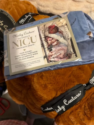 Customer's Hugs Desert Sun Blanket in copper brown, showing a NICU awareness insert.