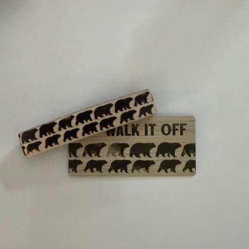 Customer's Walk It Off Bear Bracelet and product card with bear prints on a light surface.