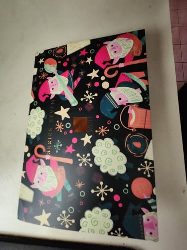 Customer's Series 3-Pack December 2022 packaging featuring a dark pattern with festive elf characters and stars.