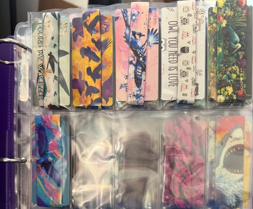 Reviewer's Bird Is The Word Mystery Bracelet collection stored in a plastic sleeve binder.