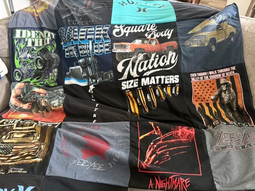 Customer's Project Repat T-Shirt Quilt featuring various graphic t-shirt panels in black, grey, and colorful prints.