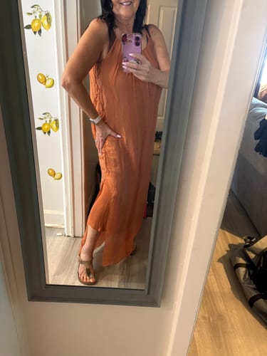 Customer's Meo Silk Maxi Dress in rust showing the delicate side slit while worn in a mirror selfie