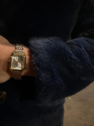 Customer's Claire De Mains vintage-inspired watch with a gold-tone rectangular face worn on a wrist.
