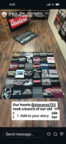 Customer's Project Repat T-Shirt Quilt displayed on a wood floor, featuring a collage of black and white graphic tees.