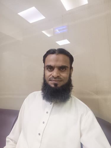 Reviewer in a light-colored shirt posing after using Sultan perfume, which they described as a great fragrance.