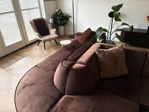 Customer's Hugs Milk Chocolate Sham on a brown couch in a bright, modern living room.
