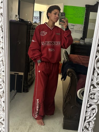 Customer's Naruto Track Pants in red, showing the oversized fit and long-sleeved matching top in a mirror reflection.