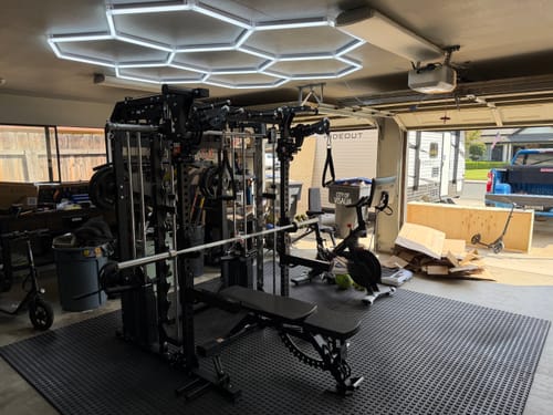 Customer's black Major Fitness B52 All-In-One Home Gym set up in a garage with hexagonal ceiling lights.