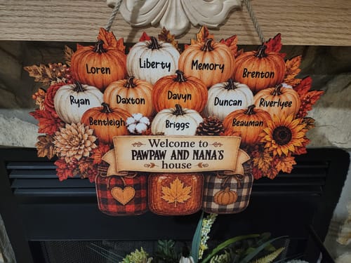 Customer's personalized Pawpaw and Nana's house wood sign featuring orange pumpkins, fall leaves, and mason jars.