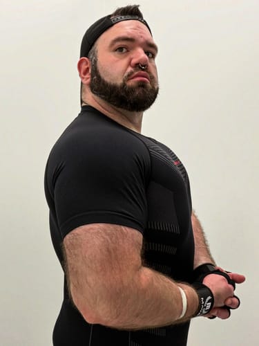 Customer's black Superhero Compression Tee worn by a person, side profile view showing fitted design.