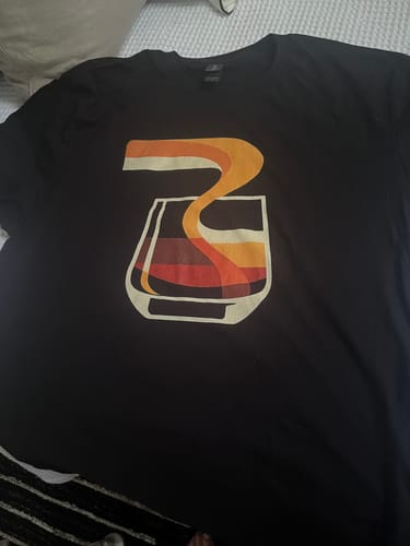 Customer's Abstract Modern Whiskey Pour T-Shirt in black, showing the retro, abstract whiskey pour graphic design.
