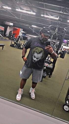 Customer's Batman Rhinestone Tee featuring Joker artwork, worn by a person in a gym setting.