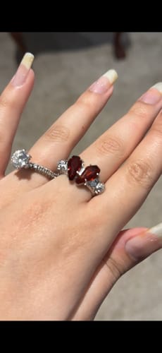 Customer's Promise Ring featuring two red coffin-shaped stones worn on a finger