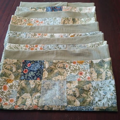 Reviewer's sage green cotton fabric used to back patterned cushions with floral designs