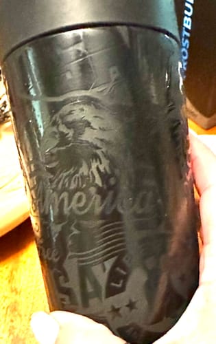 Customer's black Universal Buddy can cooler showing an engraved eagle and patriotic text.