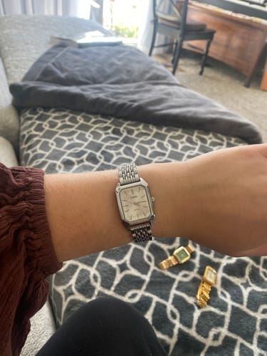Customer's silver Claire De Mains watch with a classic rectangular face worn on their wrist.
