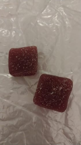 Customer's Guava Strawberry Rosin Gummies, two square red gummies with sugar coating.