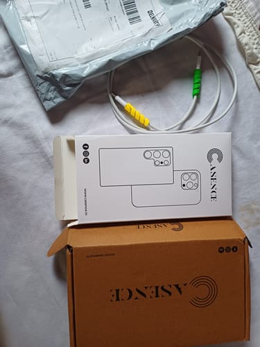 Customer's Cable Protector pack packaging, including a white charging cable with yellow and green spiral protectors.