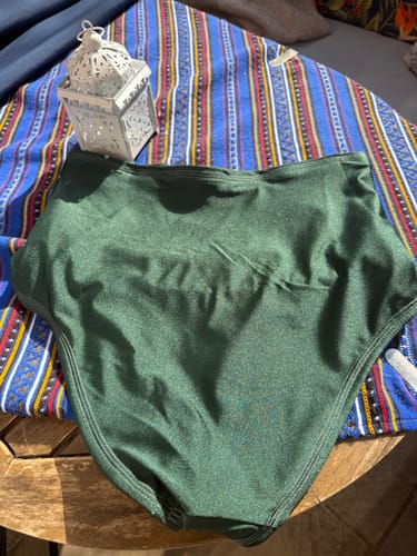 Customer's green Lycra Spandex Fabric high-waisted underwear piece resting on a patterned blue cloth.