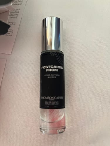 Customer's Postcards From Eau de Parfum bottle standing upright on a light surface.