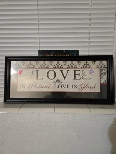 Customer's framed Love After Heartbreak book quote wall art hanging above a shelf