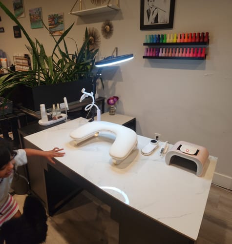 Customer's Mini Handheld Lamp, drill, and dust collector set on a clean white desk, illuminated by a lamp.