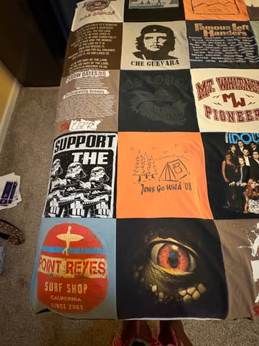Customer's Project Repat T-Shirt Quilt featuring various printed shirt panels including star wars and surf shop designs