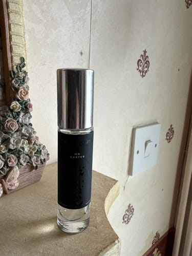 Customer's Mr Carter eau de parfum spray bottle with a silver cap, standing on a surface.