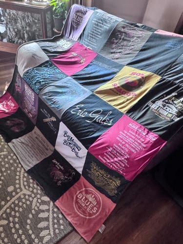 Customer's Project Repat T-Shirt Quilt featuring a patchwork design of various colorful music event shirts.